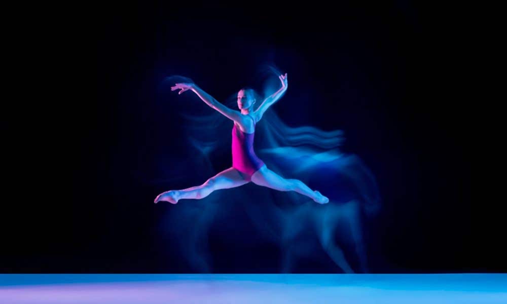 young-graceful-ballet-dancer-isolated-purple-studio-background-neon-light